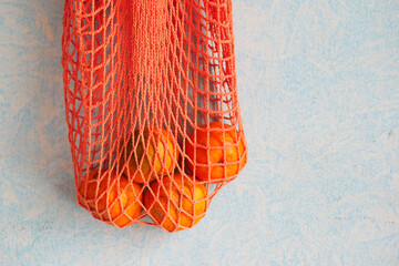 fresh orange fruit in a shopping bag on table 