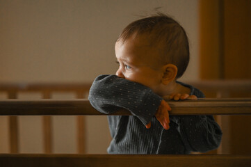 a six-month-old baby is crying in a crib