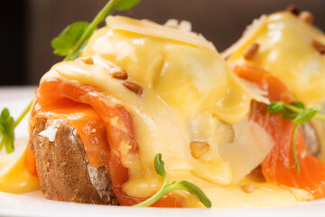 Tasty breakfast egg benedict with salmon