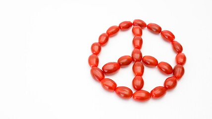 a group of cherry tomatoes make a symbols of peacefulness, isolated on white background
