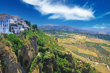 Panoramic view on ancient village Ronda located precariously close to the edge of a cliff, rural...