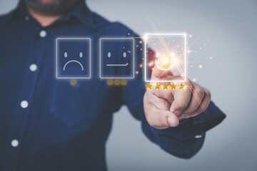 Customer service and satisfaction concept. Businessman touching the virtual screen on the icon happy smiley face to give satisfaction in service rating very impressed.