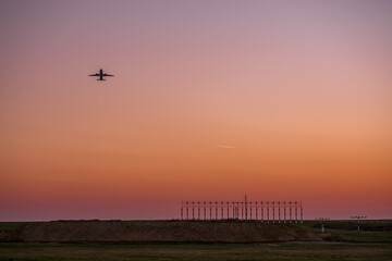 Starting plane at Düsseldorf Airport in Germany at sunset evening