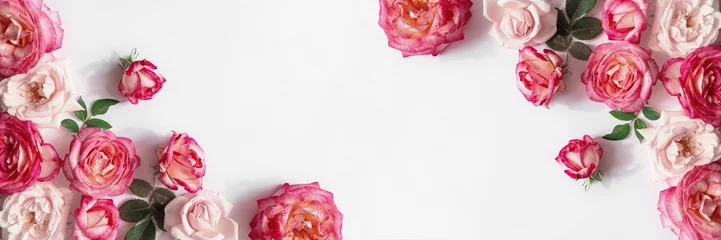  Floral composition made of beautiful pink rose buds lying on white background with sunlight. Nature concept. Summer theme. Minimal style. Top view. Flat lay © Androlia