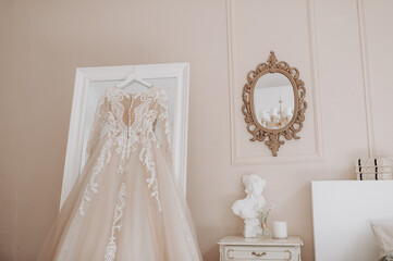 wedding dress hanging on the wall