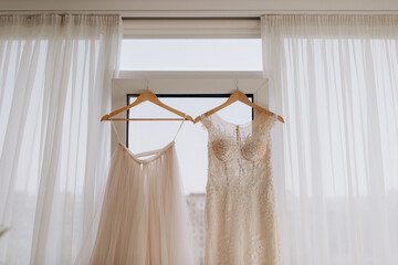 wedding dress hanging on the panoramic window