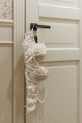 bra hanging on the door handle of the hotel room