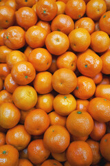 tangerines on a market stall. harvest, background. delicious mandarines as food texture.