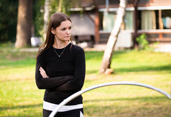 Portrait of coach on rhythmic gymnastics training with hoops outdoors