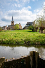 Idyllic view of water-rich landscape and old center on a dike of Nieuwerkerk aan den IJssel, Holland