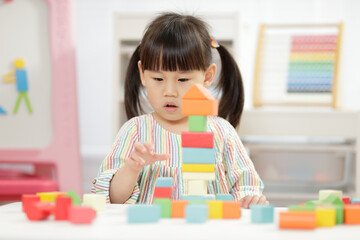  young girl playing creative toy blocks for home schooling