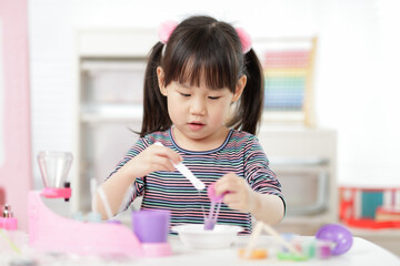 young girl making slime ar home