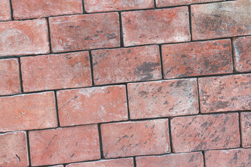 Background texture of a brick wall made of red-brown blocks, diagonal framing