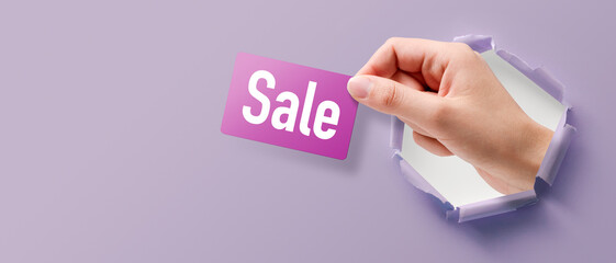 Customer holding a promotional sale card