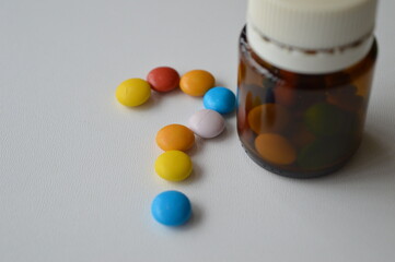 medical pills and tablets spilling out of a drug bottle