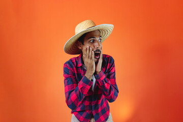 Black Man With Junina Party Outfit Scared Isolated on Orange Background.