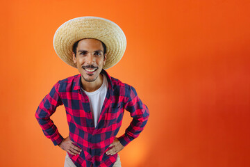 Black Man With Junina Party Outfit  Isolated on Orange Background.