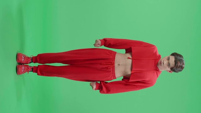 Full Body Of Terrible Asian Transgender Male Looking At Camera In The Green Screen Studio
