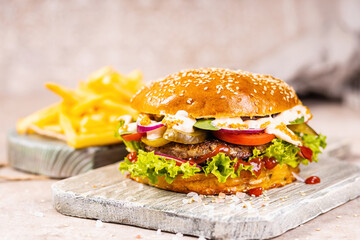 Delicious grilled burger. Beef burgers on wooden plate.