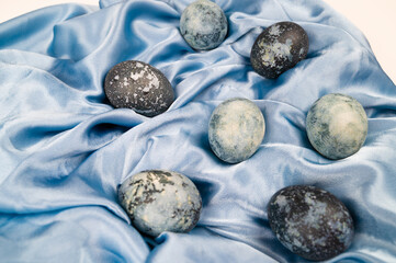 Easter eggs cracked in the form of stone texture on fabric background.