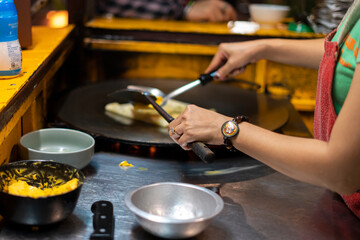 women's hands turn over sweet Thai pancakes. thai street food