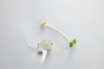tablets and capsules on a white background with a sprout. Concept medicine, medical