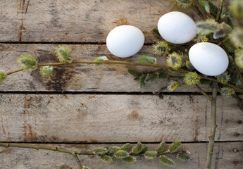 Few white eggs in   basket on   wooden background.