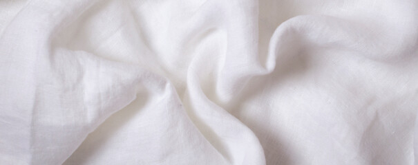 Obraz premium White crumpled linen fabric texture background. Natural linen canvas organic eco textiles background. Top view