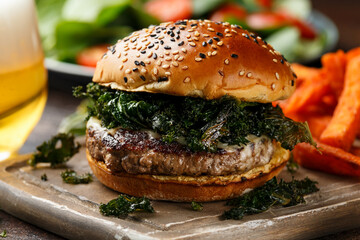 Juicy Beef burger with crispy kale, sweet potato fries and beer