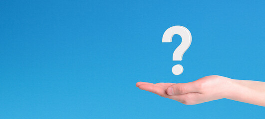 Hand holding question mark icon on blue background