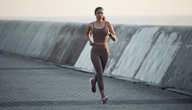 Fresh air runs are the most energising. Shot of a sporty young woman running outdoors.