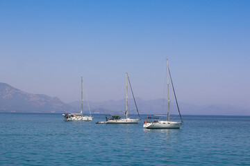 Fototapeta premium Sailing yacht in the sea against the backdrop of mountains