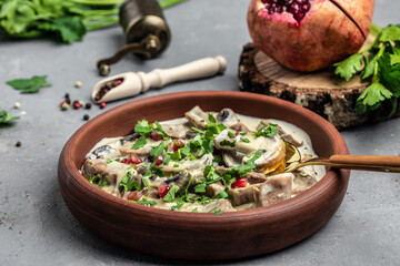 Slow cooked pork stew with mushrooms in creamy sauce served with parsley. Restaurant menu, dieting, cookbook recipe top view