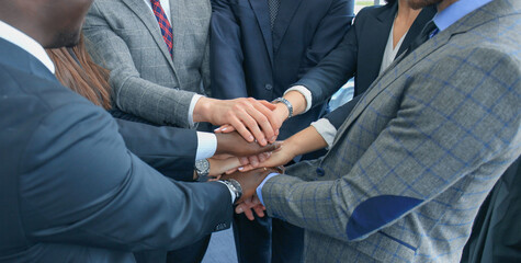 Businessman team in suit touching hands together. Selective focus