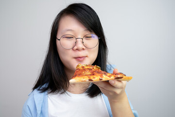 Happy glasses Asian young woman eat Pizza on white background.