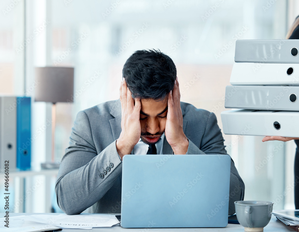 Poster why does the workload never get less. shot of a young businessman looking stressed out while working