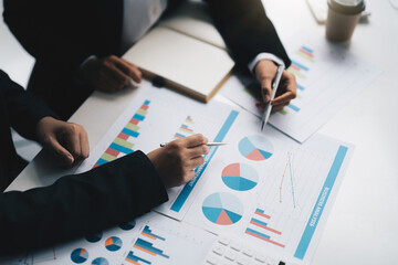 young business team meeting in the office talk about analyses chart graph marketing plan with computer laptop calculator