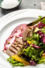 Cured meat platter of sliced ham, sausage, prosciutto, bacon. Meat antipasto, vertical image. top view. place for text