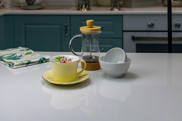 yellow teacup on a white table