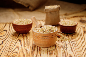Buckwheat groats in bowls and bags on a wooden background. High quality photo