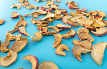 Dried apples on a blue background.