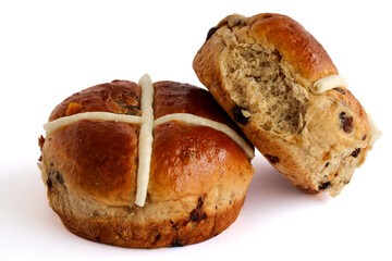 Hot cross buns on a white background. Traditional sweet buns made with raisins and currants. Usually eaten over Easter period. 