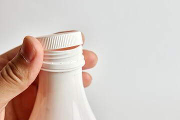 Unscrew the lid of the yogurt bottle. Healthy food. Dairy products.