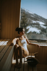 Young woman relaxing in the sauna