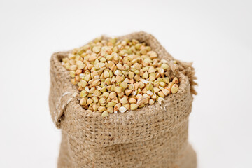 Buckwheat groats in bowls and bags isolated on a white background. High quality photo
