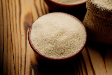 Semolina in bowls and bags on a wooden background. High quality photo