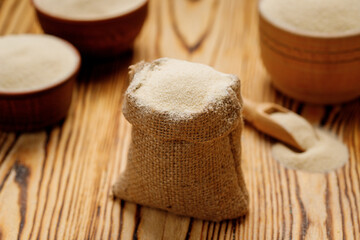 Semolina in bowls and bags on a wooden background. High quality photo