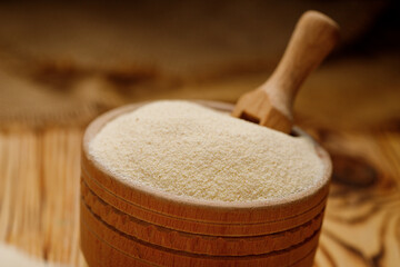 Semolina in bowls and bags on a wooden background. High quality photo