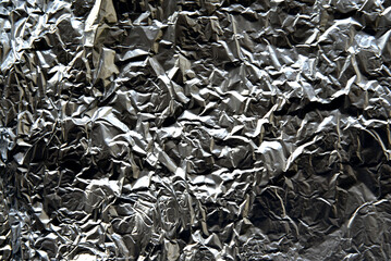 Silver background of crumpled aluminum foil