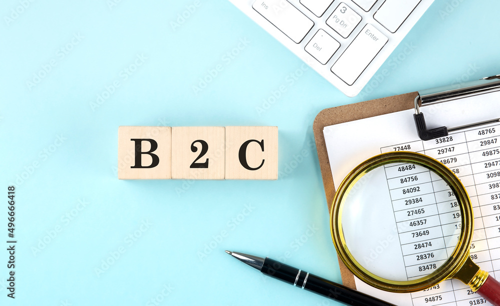 Poster b2c word on wooden cubes on blue background with chart and keyboard